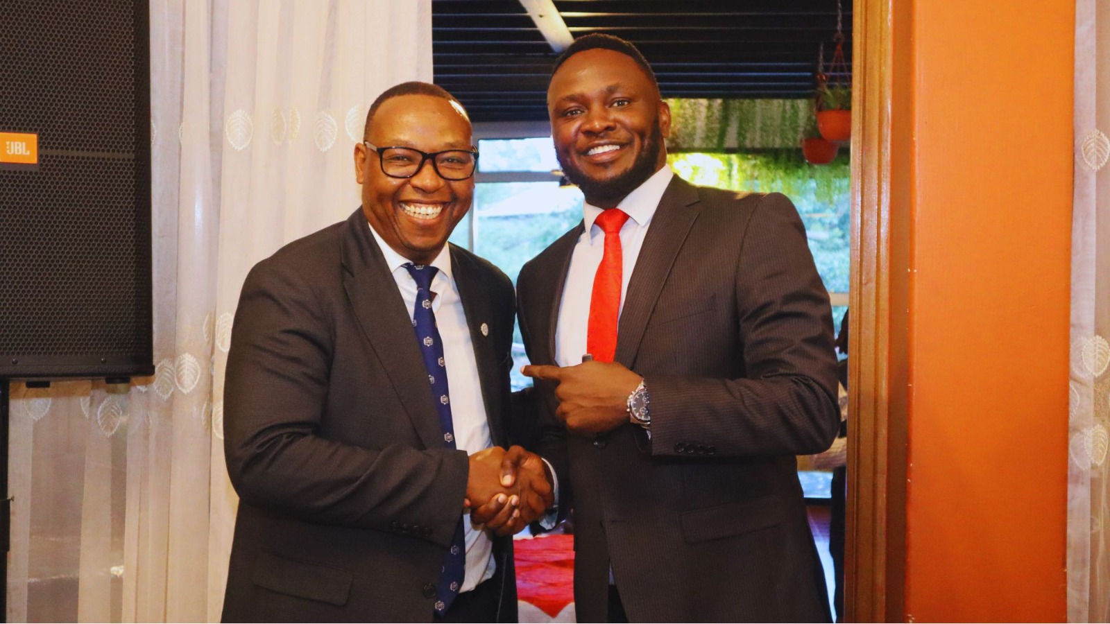 A welcome handshake in the Founders' Lounge